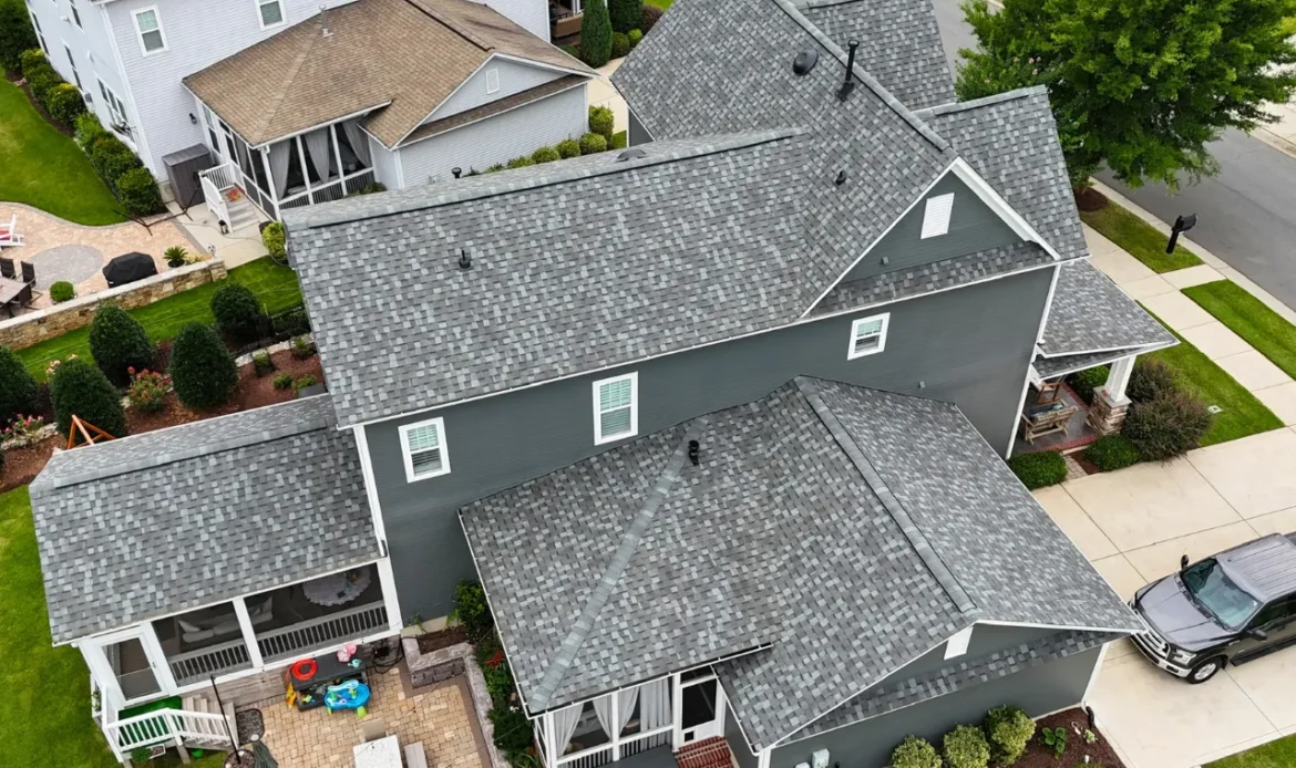 Drone photo showing residential roof being inspected for missing shingles and storm damage in Charlotte, NC