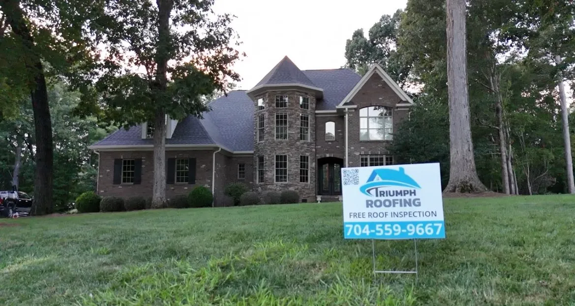 Experienced Triumph Roofing contractor performing a roof inspection on a home in Harrisburg, NC